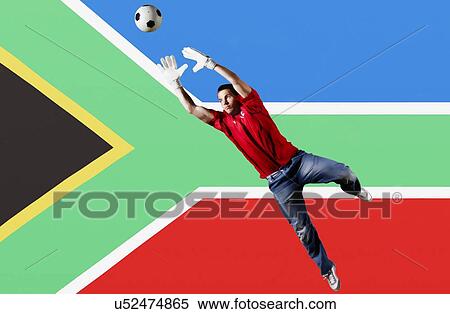 Stock Photography - Football Goalkeeper saving shot in front of South Africa National Flag. Fotosearch