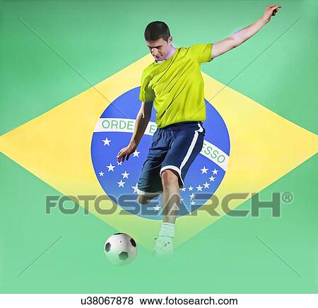 Stock Photo - Football player shooting in front of Brazil National Flag. Fotosearch