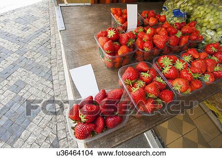 Picture - Fresh strawberries and grapes at outdoor market. Fotosearch