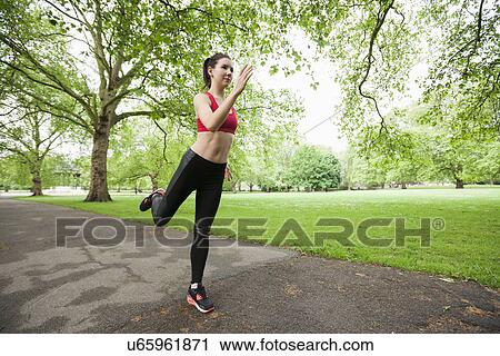 Stock Image - Full length of beautiful fit woman jogging in park. Fotosearch