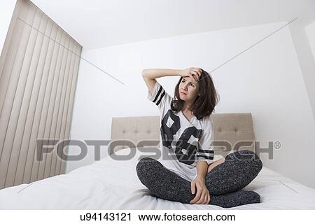 Full length of worried woman looking away in bed View Large Photo Image Stock Image - Full length of worried woman looking away in bed. Fotosearch