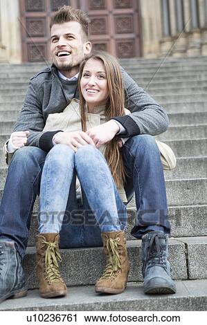 Full length of young couple sitting on steps outdoors View Large Photo Image Stock Image - Full length of young couple sitting on steps outdoors. Fotosearch