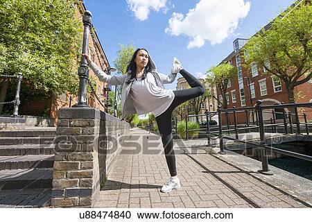Full length of young fit woman exercising on sidewalk View Large Photo Image Stock Image - Full length of young fit woman exercising on sidewalk. Fotosearch