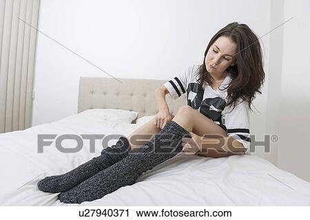 Full length of young woman wearing socks in bed View Large Photo Image Stock Image - Full length of young woman wearing socks in bed. Fotosearch
