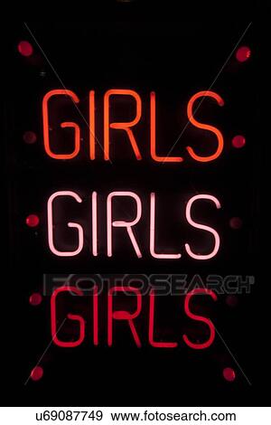 Stock Photo - Girls written in neon lights against black background. Fotosearch