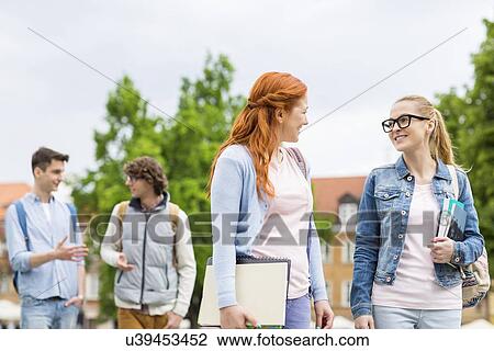 Group of college friends walking outdoors View Large Photo Image Stock Image - Group of college friends walking outdoors. Fotosearch