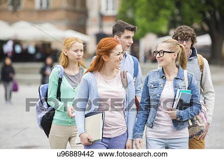 Stock Image - Group of college friends walking outdoors. Fotosearch