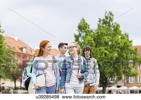 Group of college friends walking outdoors View Large Photo Image Stock Photo - Group of college friends walking outdoors. Fotosearch
