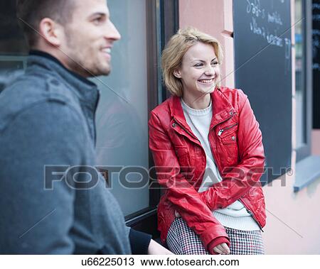 Happy young couple sitting outside cafe View Large Photo Image Stock Image - Happy young couple sitting outside cafe. Fotosearch