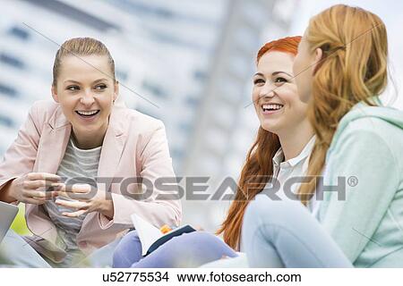Happy young female college friends studying outdoors View Large Photo Image Picture - Happy young female college friends studying outdoors. Fotosearch