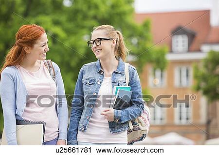 Happy young female college friends walking outdoors View Large Photo Image Stock Image - Happy young female college friends walking outdoors. Fotosearch