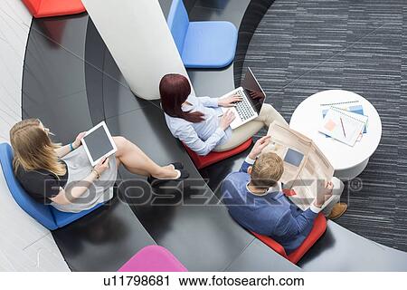 High angle view of business people sitting in office lobby View Large Photo Image Stock Image - High angle view of business people sitting in office lobby. Fotosearch