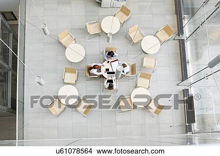 Picture - High angle view of businesswomen working in office canteen. Fotosearch