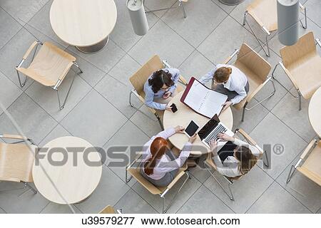 High angle view of businesswomen working in office canteen View Large Photo Image Stock Photo - High angle view of businesswomen working in office canteen. Fotosearch