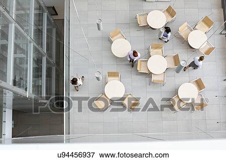 High angle view of businesswomen walking at office canteen View Large Photo Image Stock Photo - High angle view of businesswomen walking at office canteen. Fotosearch