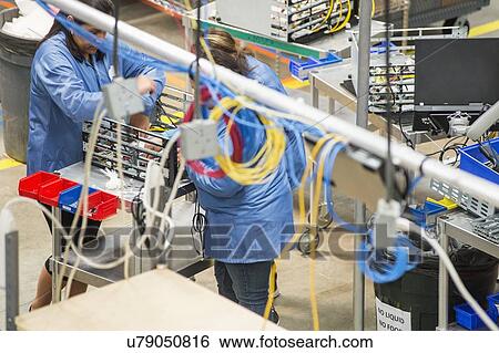 High angle view of female technicians repairing computer part in electronics industry View Large Photo Image Stock Photograph - High angle view of female technicians repairing computer part in electronics industry. Fotosearch