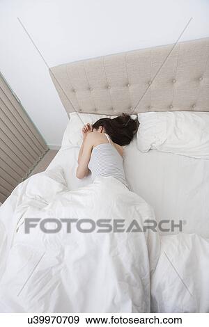 High angle view of woman sleeping in bed View Large Photo Image Stock Photo - High angle view of woman sleeping in bed. Fotosearch