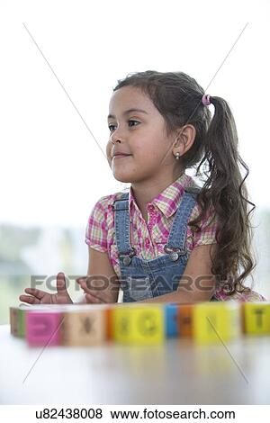 Little girl playing with blocks at home View Large Photo Image Stock Photo - Little girl playing with blocks at home. Fotosearch