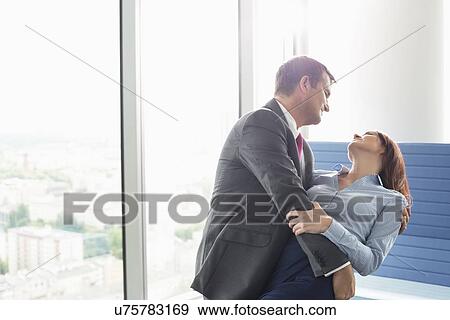Loving business couple dancing in office View Large Photo Image Stock Photo - Loving business couple dancing in office. Fotosearch