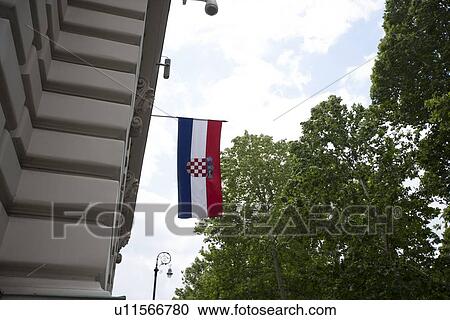 Stock Image - Low angle view of Croatian flag hanging on parliament building, Zagreb, Croatia. Fotosearch