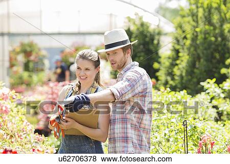 Male gardener discussing with supervisor outside greenhouse View Large Photo Image Stock Photo - Male gardener discussing with supervisor outside greenhouse. Fotosearch