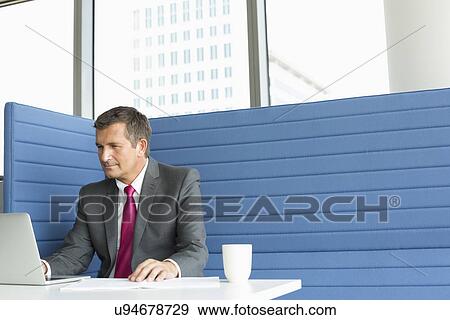 Mature businessman using laptop at desk View Large Photo Image Stock Photo - Mature businessman using laptop at desk. Fotosearch