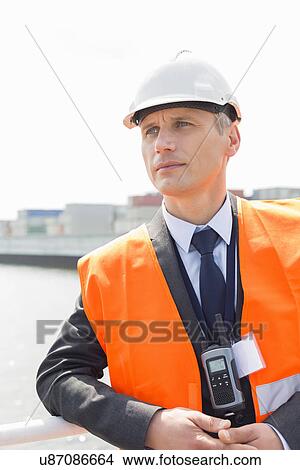 Picture - Middle-aged male worker in shipping yard. Fotosearch