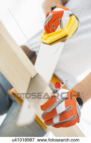 Midsection of man sawing plank View Large Photo Image Stock Photo - Midsection of man sawing plank. Fotosearch