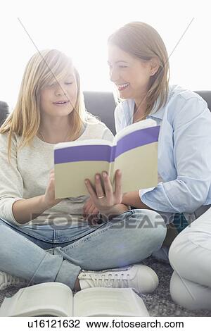 Mother assisting daughter in homework at home View Large Photo Image Stock Image - Mother assisting daughter in homework at home. Fotosearch