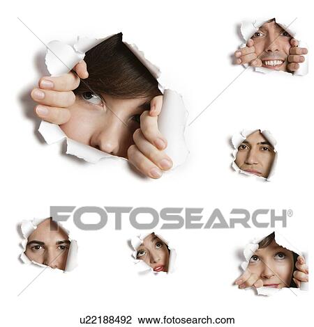 Stock Image - Multiethnic people looking through ripped paper holes. Fotosearch