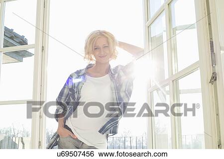 Stock Photograph - Portrait of beautiful mid-adult woman at home. Fotosearch