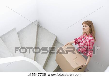 Portrait of beautiful woman carrying cardboard box View Large Photo Image Stock Photograph - Portrait of beautiful woman carrying cardboard box. Fotosearch