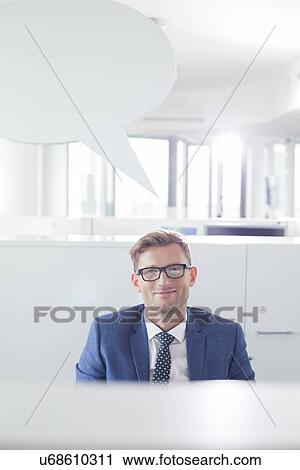 Portrait of confident businessman with speech bubble in office View Large Photo Image Stock Image - Portrait of confident businessman with speech bubble in office. Fotosearch