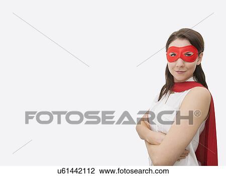 Portrait of confident businesswoman dressed as superhero standing arms crossed in office View Large Photo Image Stock Image - Portrait of confident businesswoman dressed as superhero standing arms crossed in office. Fotosearch