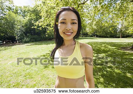 Stock Photography - Portrait of confident fit woman at park. Fotosearch