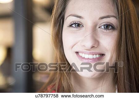 Stock Photo - Portrait of confident woman smiling in cafe. Fotosearch