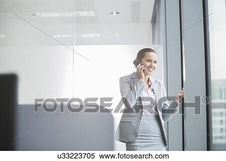 Portrait of confident young businesswoman in office View Large Photo Image Stock Photography - Portrait of confident young businesswoman in office. Fotosearch
