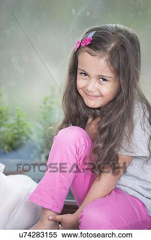 Portrait of cute little girl relaxing at home View Large Photo Image Stock Photography - Portrait of cute little girl relaxing at home. Fotosearch