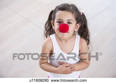 Portrait of cute little girl wearing clown nose at home View Large Photo Image Stock Image - Portrait of cute little girl wearing clown nose at home. Fotosearch