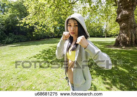 Portrait of determined fit woman practicing boxing at park View Large Photo Image Stock Photography - Portrait of determined fit woman practicing boxing at park. Fotosearch