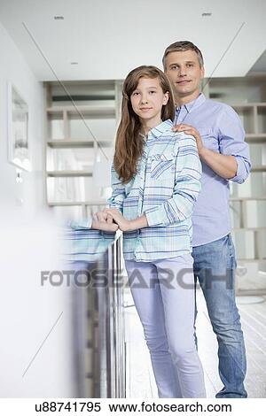 Portrait of father and daughter standing together at home View Large Photo Image Stock Photography - Portrait of father and daughter standing together at home. Fotosearch