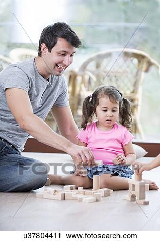 Portrait of happy father and daughters playing with abacus in house View Large Photo Image Stock Image - Portrait of happy father and daughters playing with abacus in house. Fotosearch