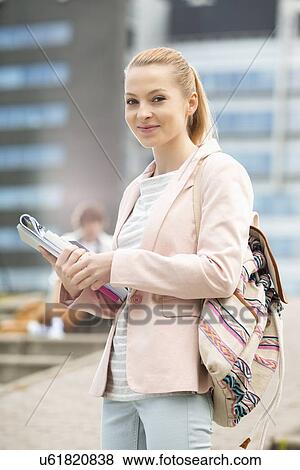 Portrait of happy young female student at college campus View Large Photo Image Stock Photo - Portrait of happy young female student at college campus. Fotosearch