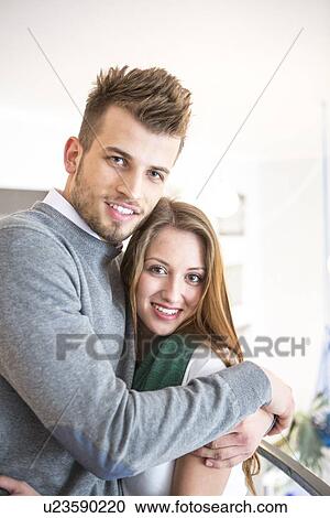 Portrait of loving young man hugging woman at cafe View Large Photo Image Stock Image - Portrait of loving young man hugging woman at cafe. Fotosearch