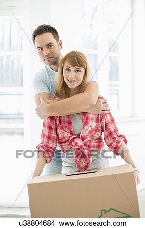 Portrait of man embracing woman in new house View Large Photo Image Picture - Portrait of man embracing woman in new house. Fotosearch