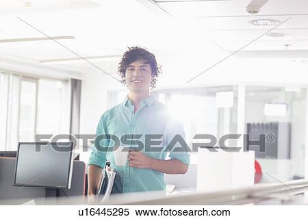 Portrait of smiling businessman having coffee in creative office View Large Photo Image Stock Photography - Portrait of smiling businessman having coffee in creative office. Fotosearch