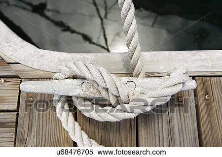 Rope tied to a jetty cleat View Large Photo Image Stock Photography - Rope tied to a jetty cleat. Fotosearch