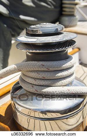 Rope wound around winch on sailboat View Large Photo Image Stock Photograph - Rope wound around winch on sailboat. Fotosearch
