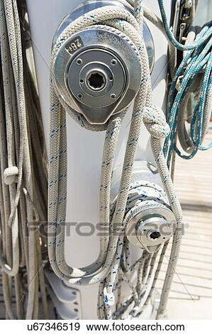 Stock Photo - Ropes wound around winches on sailboat. Fotosearch