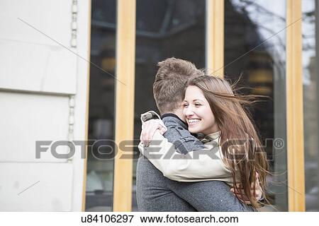Side view of romantic couple hugging outside cafe View Large Photo Image Stock Photo - Side view of romantic couple hugging outside cafe. Fotosearch
